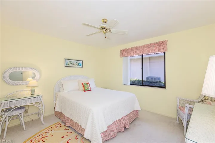 Bedroom featuring light carpet and ceiling fan