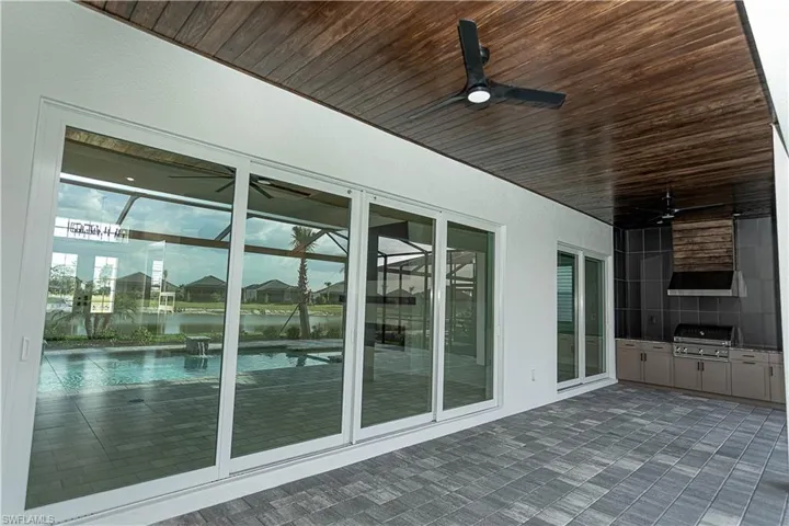 View of patio featuring a ceiling fan, custom tongue and groove ceiling upgrade, installed custom outdoor kitchen