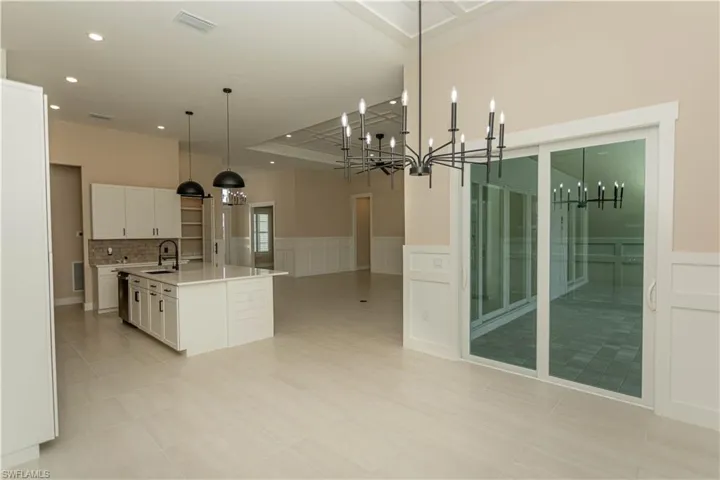 Breakfast nook off kitchen with views of pool/spa/golf course, lake, upgraded decorative ceiling, wainscoting on walls, casing on windows, and upgraded plantation shutters