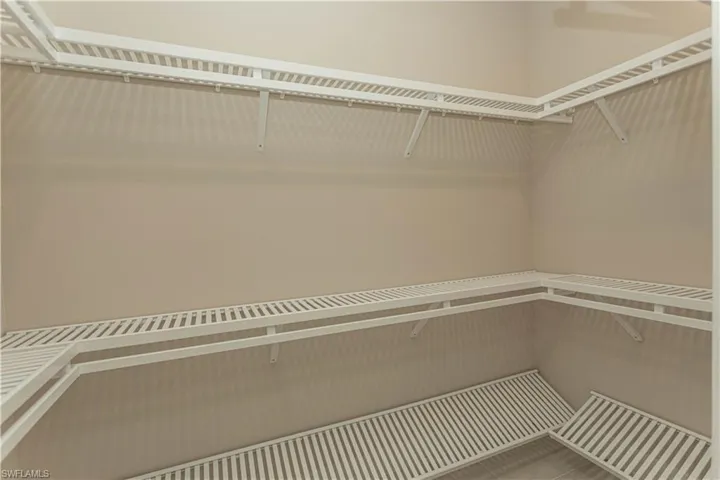 View of walk in closet #2 with custom shelving