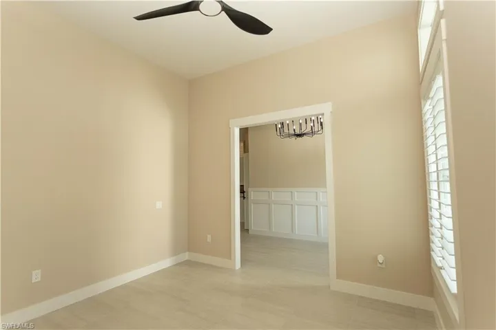 Bonus room, use as formal dining or office, den, featuring a ceiling fan and hanging lights