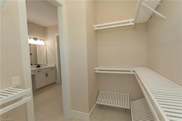 View of walk in closet #1 with custom shelving