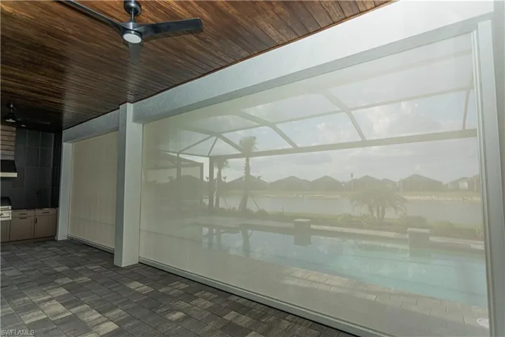 View of lanai with custom hurricane storm screen, protect outdoor furniture without moving it inside!