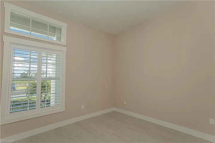 Unfurnished bonus room, use as formal dining or den, featuring baseboards, window casing