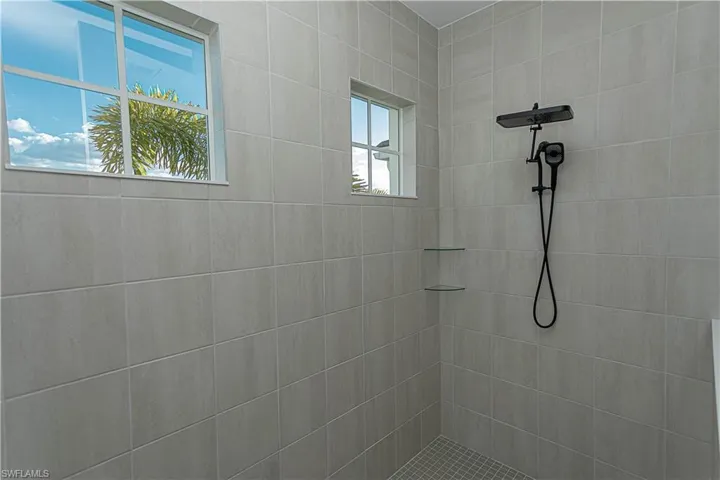Master bathroom with tiled shower, upgraded matte black fixtures