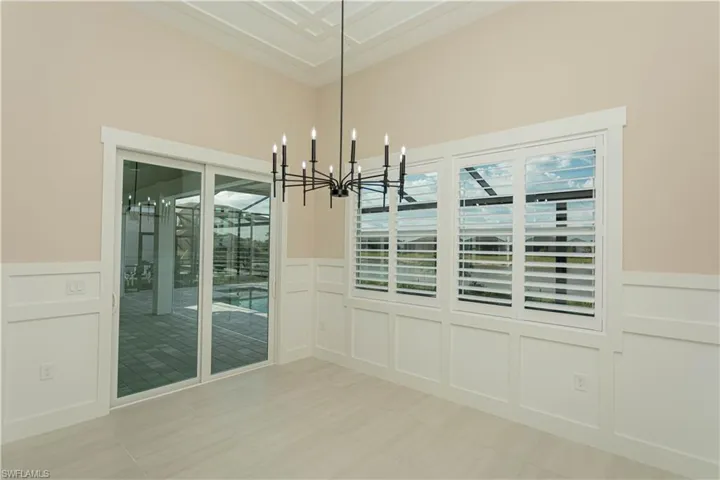 Breakfast nook off kitchen with views of pool/spa/golf course, lake, upgraded decorative ceiling, wainscoting on walls, casing on windows, and upgraded plantation shutters
