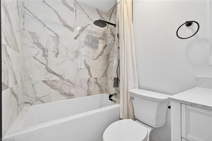 Full bathroom with shower / bath combo and vanity