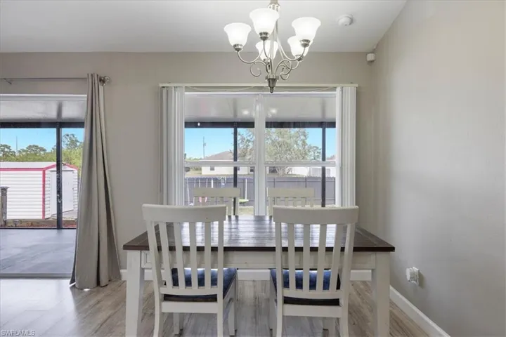 Dining area with a chandelier and light wood-type flooring