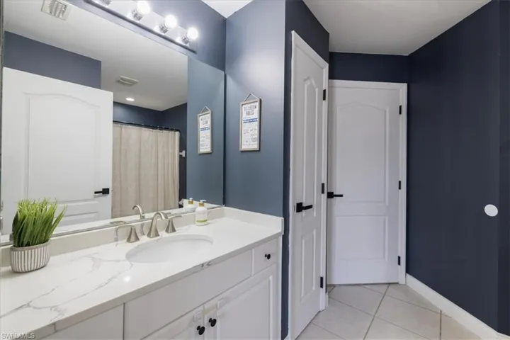 Bathroom featuring tile patterned floors and vanity