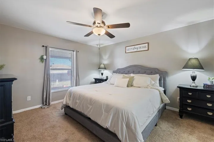Bedroom featuring light carpet and ceiling fan
