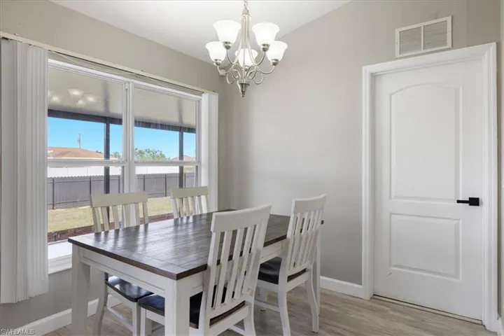 Dining space featuring light hardwood / wood-style floors and a notable chandelier
