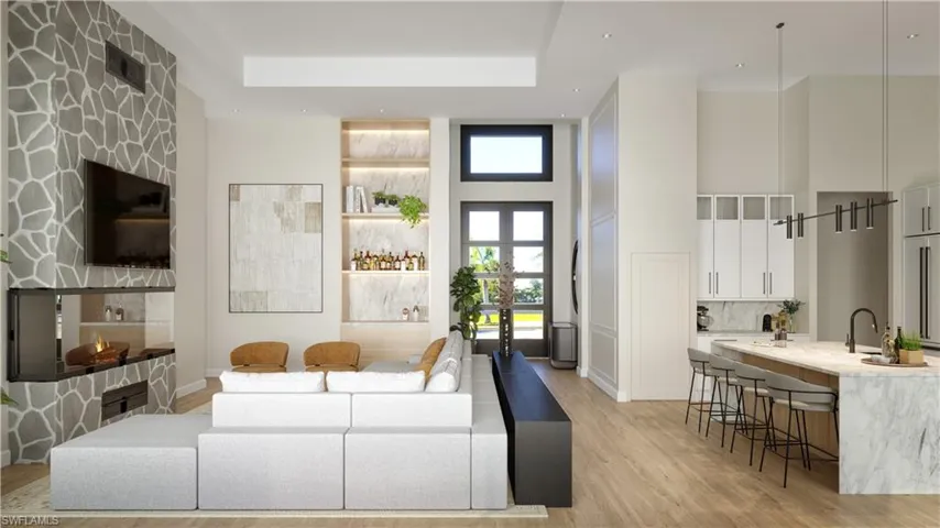 Living area with a towering ceiling and light wood-look tile flooring and a high ceiling