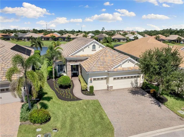 View of front of house with a garage and a front yard