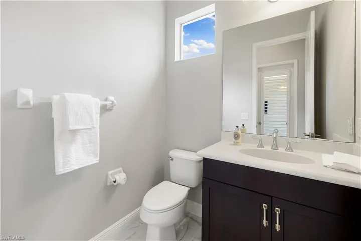 Guest bathroom & pool bath featuring tile patterned floors, toilet, and vanity