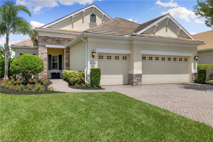 View of front of home featuring a garage and a front yard