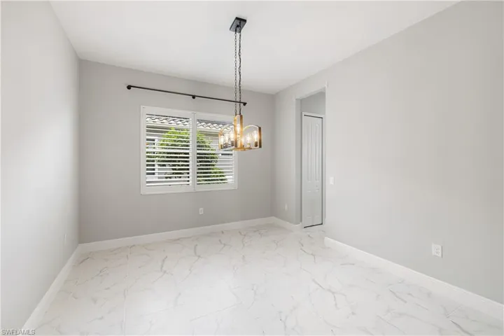 Dining room featuring a notable chandelier and tile patterned flooring