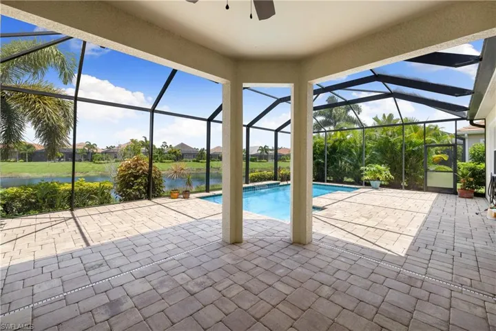 Unfurnished sunroom with a water view and ceiling fan