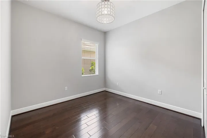 Spare bed room featuring hardwood / wood-style flooring