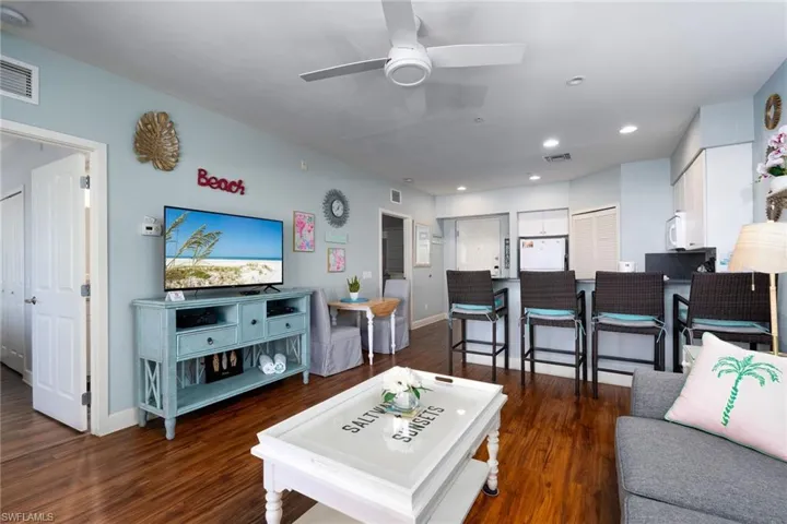 Open-concept living area with wood-finish flooring and light blue walls