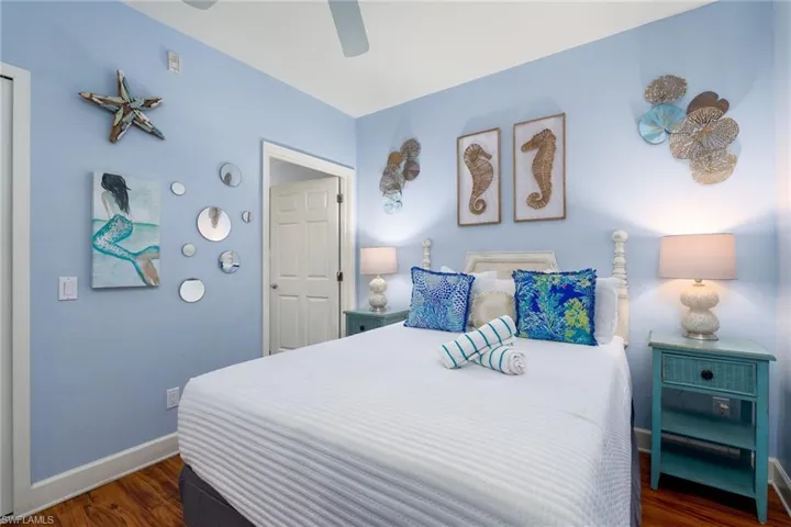 Bedroom featuring light blue walls and wood-finish flooring