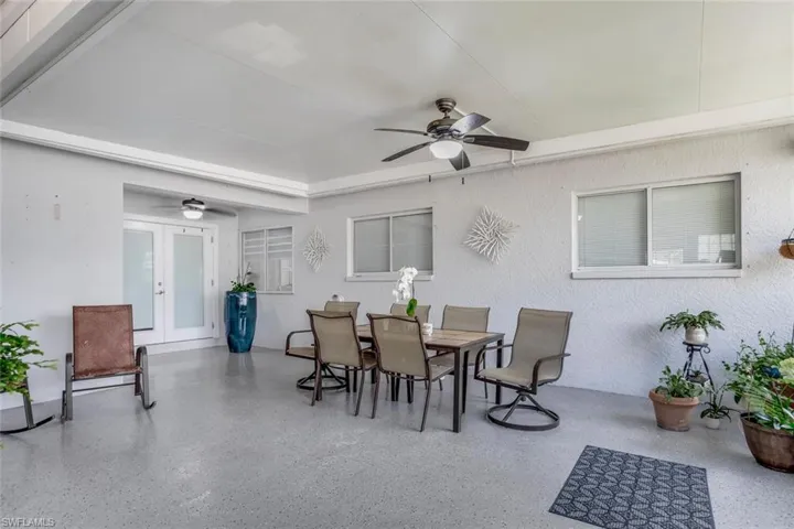 View of patio with ceiling fan and french doors