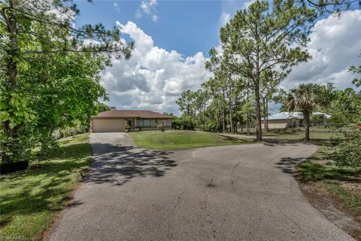 View of front of home with a garage and a front yard