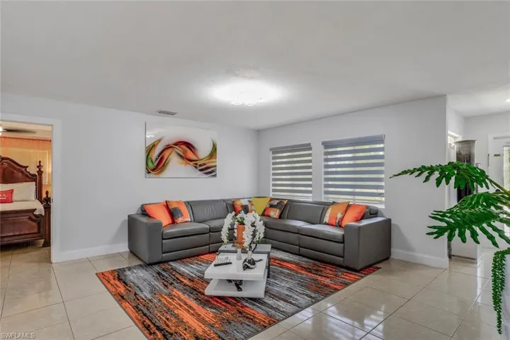 Living room featuring light tile floors