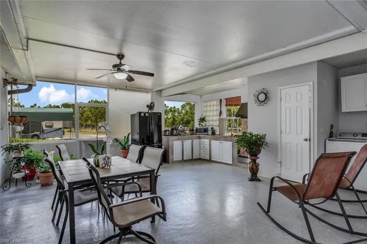 Sunroom with ceiling fan and washer / clothes dryer