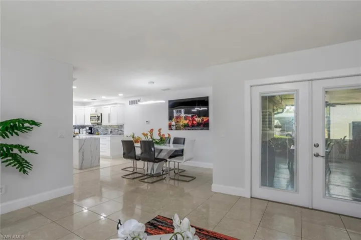 Dining room featuring light tile floors and french doors