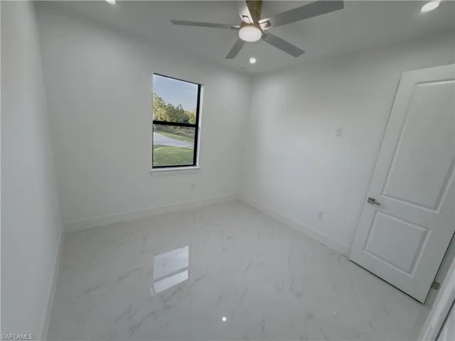 Spare room featuring recessed lighting and light marble finish flooring