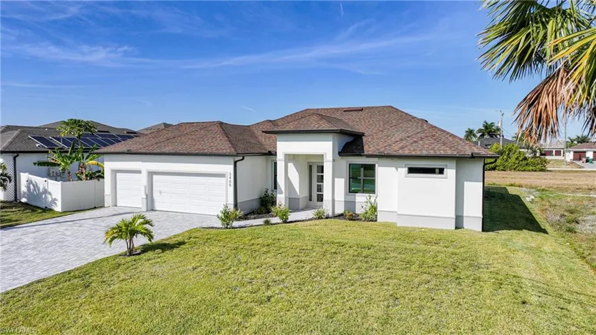 Prairie-style house with stucco siding, decorative driveway, a garage, and a shingled roof