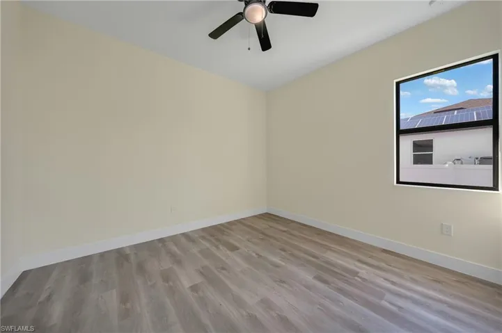 Spare room with baseboards and light wood-style floors