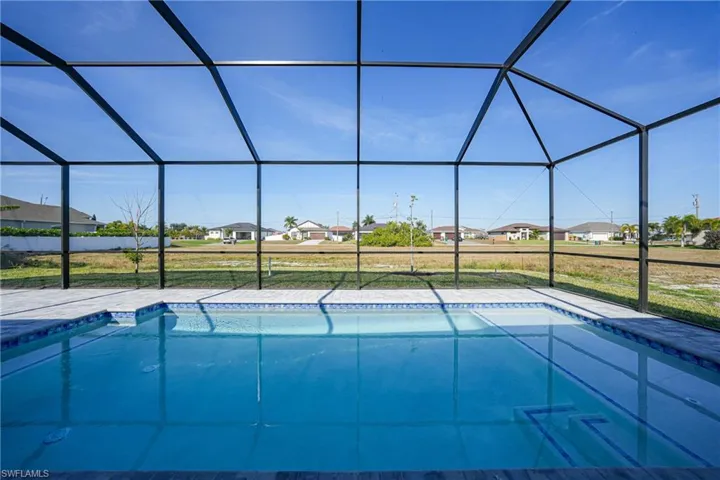 View of pool with a lanai, a sunroom, a residential view, and a yard