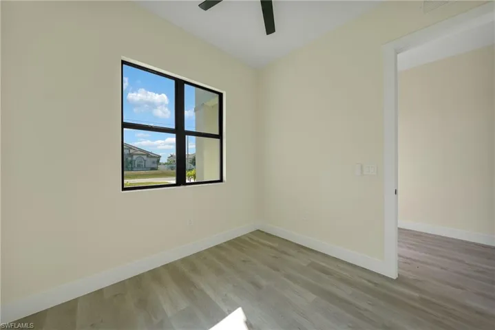 Spare room featuring light wood-style floors and a ceiling fan