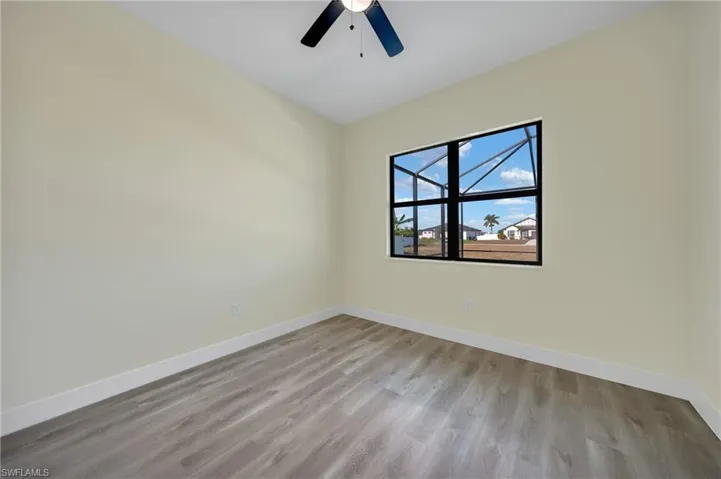 Empty room featuring light wood-style flooring and ceiling fan