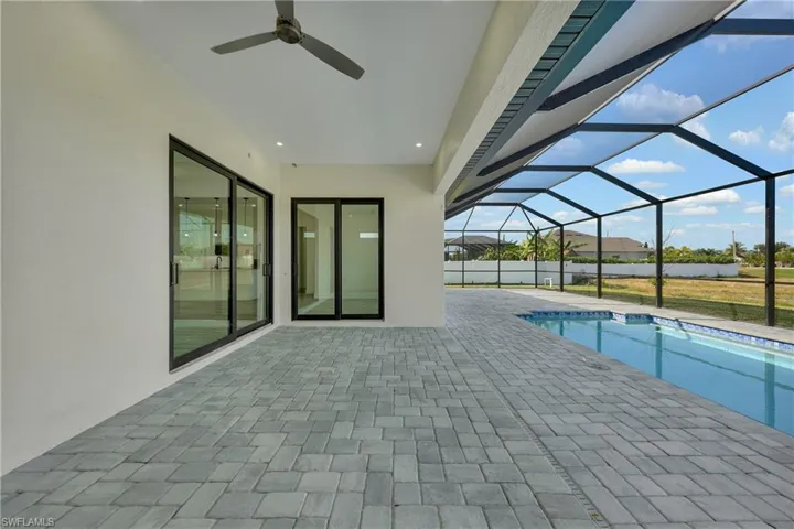 Swimming pool with a sunroom, a patio area, and a lanai