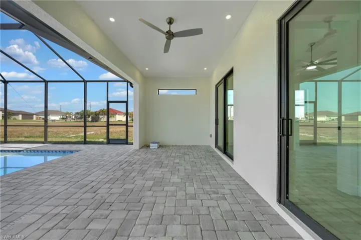 Outdoor pool featuring a lanai, a sunroom, a patio, and a residential view