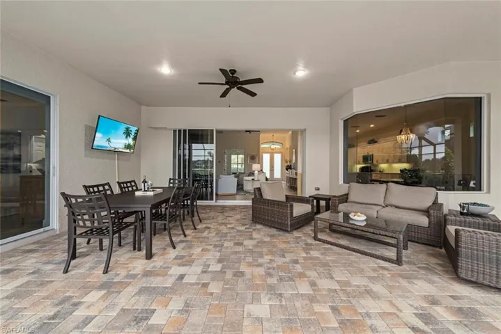 Expansive covered patio featuring paver flooring, a ceiling fan, and recessed lighting