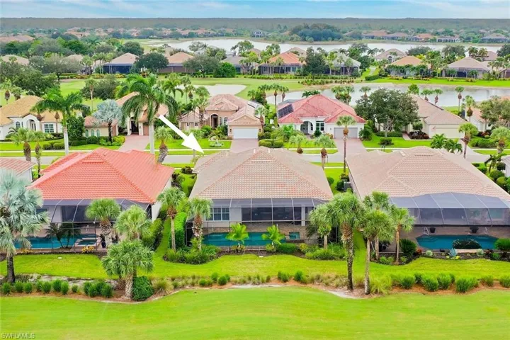 Single family home in TwinEagles with a screened-in lanai with a pool, spa, tropical landscaping and a tile roof