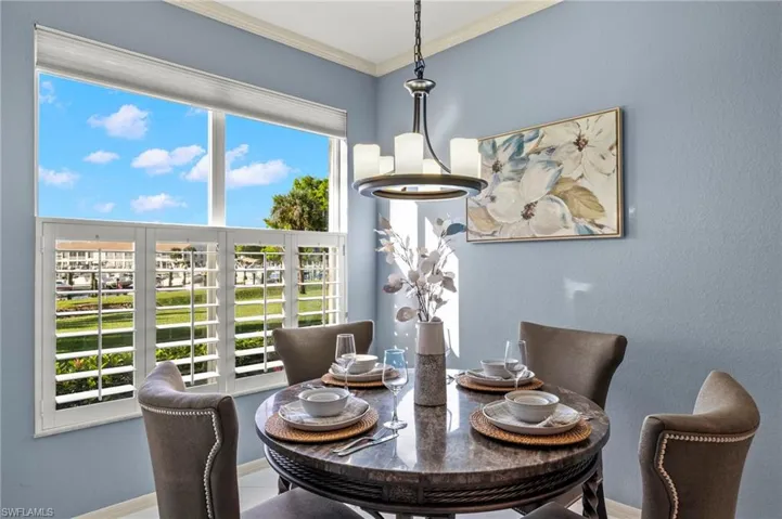 Dining area featuring a chandelier and ornamental molding