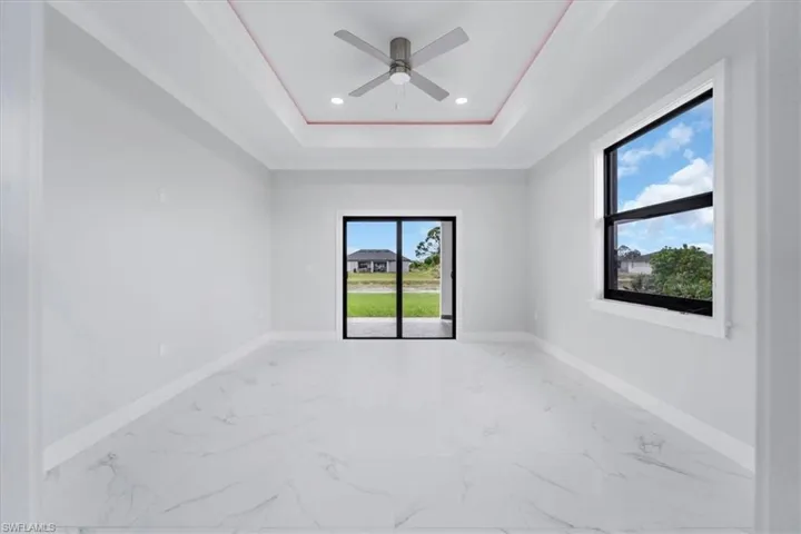 Unfurnished room featuring light marble finish floors, a ceiling fan, recessed lighting, and crown molding