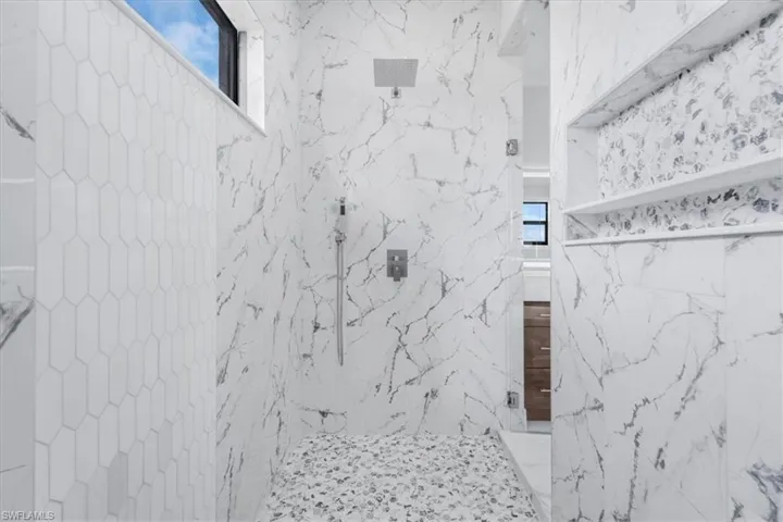 Bathroom with a marble finish shower