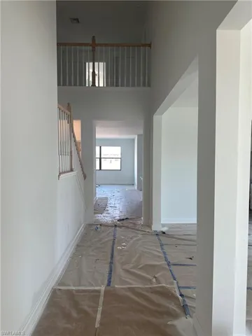Corridor featuring a high ceiling