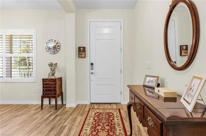 Entrance foyer featuring light wood-style flooring and baseboards
