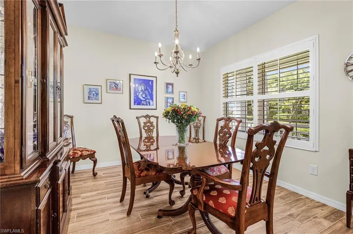 Dining room featuring wood finish floors and a chandelier