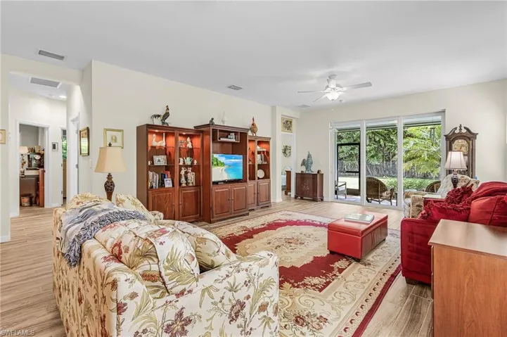 Living area featuring light wood-type flooring and ceiling fan