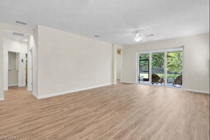 Unfurnished living room with light wood-type flooring and ceiling fan