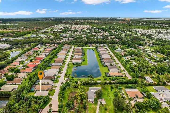 Aerial perspective of suburban area featuring a large body of water