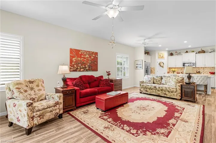 Living area featuring wood tiled floors, recessed lighting, and ceiling fan