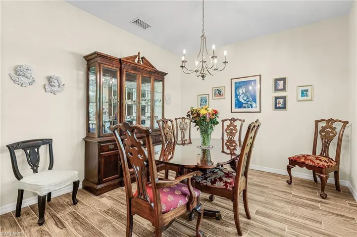 Dining room with a chandelier and wood finish floors